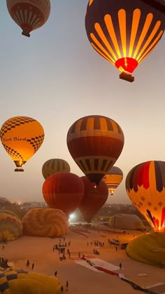 many hot air balloons flying in the sky