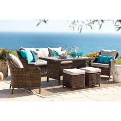 an outdoor patio furniture set with blue and white pillows