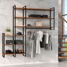 an open shelving unit with clothes hanging on it