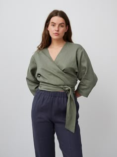 "CLAIRE is a linen wrap top. DETAILS - Wrap around blouse - 3/4 sleeves - Cropped length - 100% lightweight European linen fabric - Cut and sewn to order just for you in our studio COLOR - Sage Green, you can also choose other colors above - Fabric samples are available here https://www.etsy.com/listing/586569696/linen-fabric-samples SIZING & FIT - Relaxed fit - Model is 5'6\" / 172 cm and wearing a size M CARE FOR LINEN - Machine wash up to 30ºC/86ºF gentle cycle - Lay flat to dry or tumble dry low - Warm iron if needed - Do not bleach SIZE GUIDE Size conversion guide Size XS (US 0-2, IT 36-38, UK 4-6, Japan 3-5, France 32-34) Size S (US 4-6, IT 40-42, UK 8-10, Japan 7-9, France 36-38) Size M (US 8-10, IT 44-46, UK 12-14, Japan 11-13, France 40-42) Size L (US 12-14, IT 48-50, UK 16-18, Ja Long Sleeve Wrap Top For Summer Workwear, Summer Long Sleeve Wrap Top For Work, Wrap Around Blouse, Bangkok Dress, Linen Wrap Top, Linen Kimono, Linen Crop Top, Studio Color, Linen Tank Top