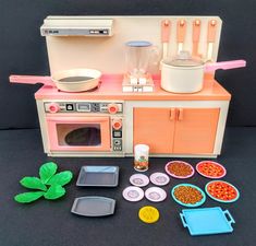 a toy kitchen set with food and utensils