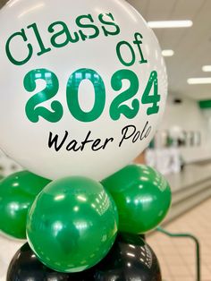 a class of 202 water polo balloon sitting on top of an inflatable ball