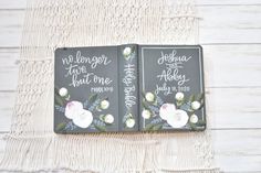 two wedding books with floral designs on them