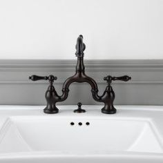 a bathroom sink with two faucets on it