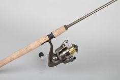 a fishing rod and reel on a gray background