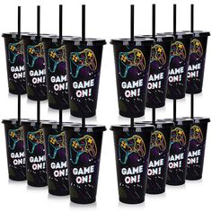 six game on cups with black straws and neon colored designs are shown in this image