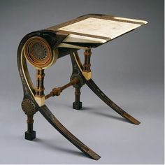 an old wooden table with a clock on it's top and two curved legs