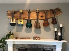 a fireplace with guitars hanging on the wall