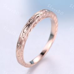 an engraved wedding ring on a white background