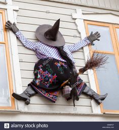 a scarecrow hanging on the side of a house