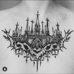 the back of a man's chest with an intricate castle tattoo on his chest