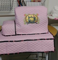 pink quilted chair covers with sewing machine on them