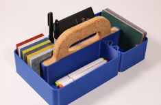 two blue bins filled with files and folders on top of a white table