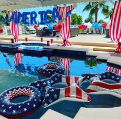 an american themed pool with inflatable floats