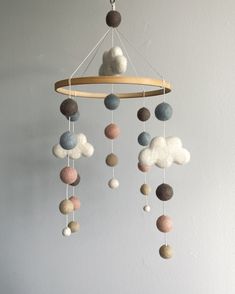 a mobile made out of felt balls hanging from the ceiling