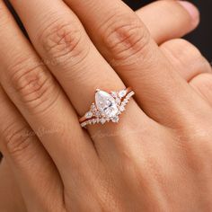 a woman's hand with an engagement ring on her finger and diamond band around it