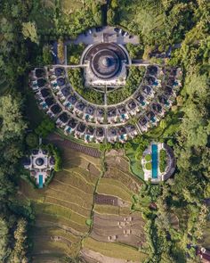 an aerial view of a circular building surrounded by trees