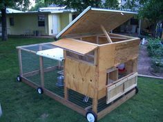 an outdoor chicken coop with the roof open