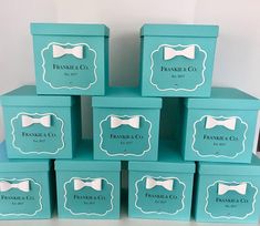 six blue boxes with white bow ties on them