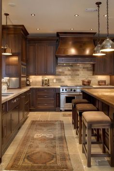 a large kitchen with wooden cabinets and an area rug on the floor in front of it