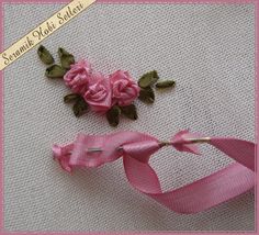 two pink roses are being sewn together