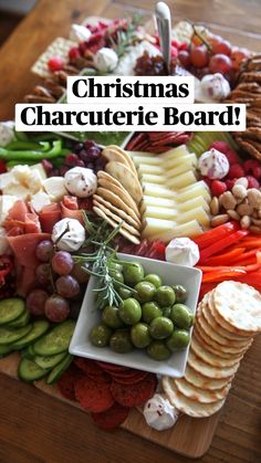 an assortment of cheeses, crackers and vegetables on a platter