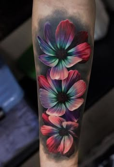 colorful flower tattoo on the leg