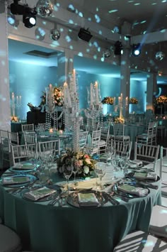 a banquet room with round tables and white chairs