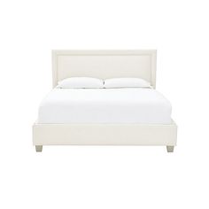 a bed with white linens and pillows on top of it, against a white background