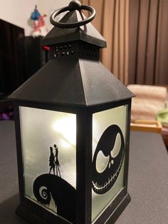 a lantern with an image of jack and sally from the nightmare before it's gone