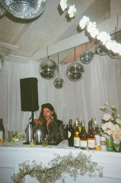 a man sitting at a bar with lots of bottles