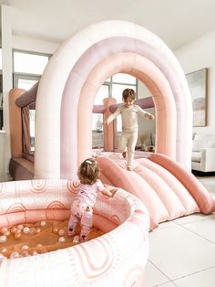 two children playing in an inflatable pool