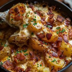 a skillet filled with potatoes covered in bacon and cheese