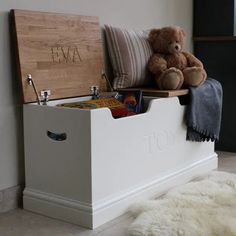 a teddy bear sitting on top of a toy chest