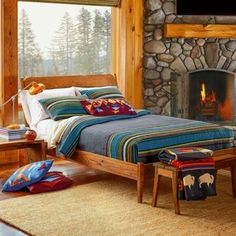 a bed sitting next to a fire place in a bedroom