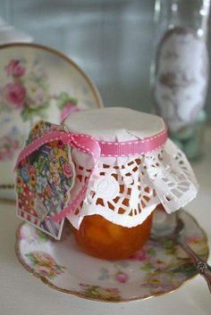 a small jar filled with jam sitting on top of a plate