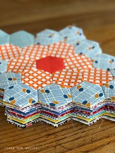 several pieces of fabric sitting on top of a wooden table