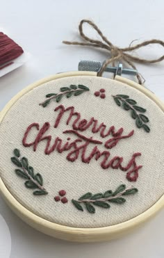 a cross stitch christmas ornament with the words merry christmas on it