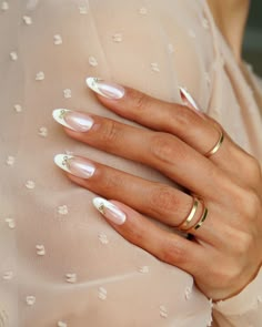 a woman's hand with two rings on it