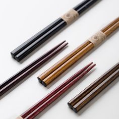 several different types of chopsticks on a white surface