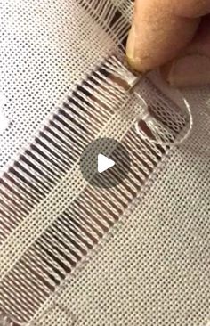 someone is stitching the side of a piece of fabric with their thumbnails