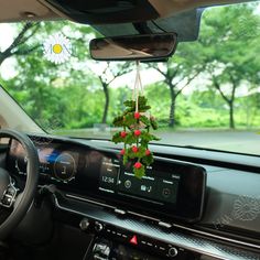 a car dashboard with flowers hanging from the dash