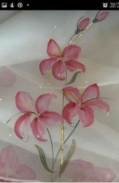 some pink flowers are on a white sheet