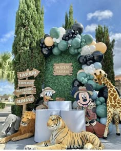 an animal themed birthday party with balloons and jungle animals on the front lawn at disney's animal kingdom