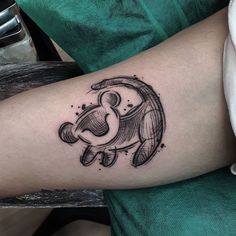 a black and white tattoo on the arm of a person with an elephant in it