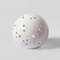 a white ball with gold stars on it