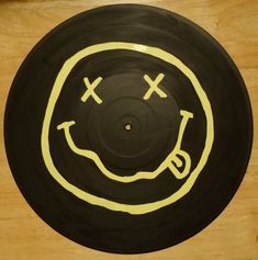 a wooden table topped with a black and yellow disc