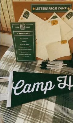 the camp sign is next to some papers