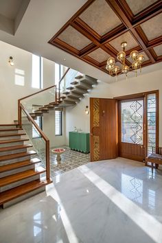 an empty room with stairs and windows