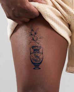 a close up of a person with a tattoo on their thigh and the bottom half of his leg